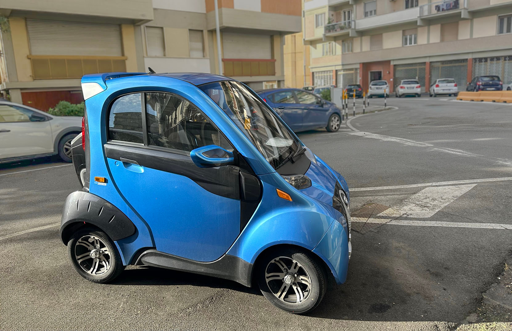 Small, blue micro-car in Florence Italy.